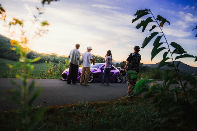 Magazine spread, four people around a car at a roadside pull-off